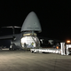 The special flatbed truck has to be lined up perfectly with the front cargo bay of the C-5.
